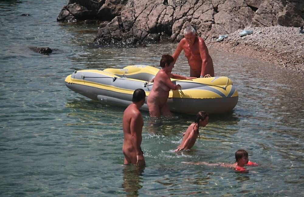 Lone Nudist in Yellow Boat photos - Naturism teaches respect for the body—both your own and others